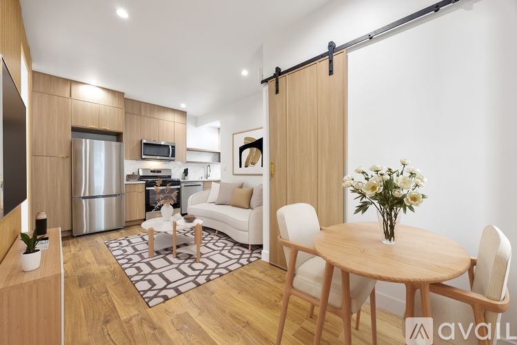 A modern kitchen with wooden cabinets and a dining table set with a vase of flowers.