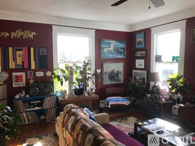 A living room with a couch, a coffee table, and a ceiling fan.