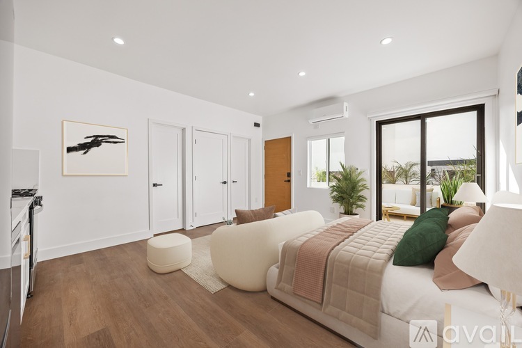 A bedroom with a large bed and a painting of a bird on the wall.