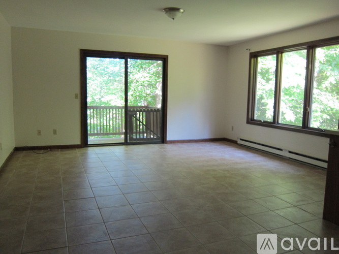 A room with a sliding glass door leading to a balcony.