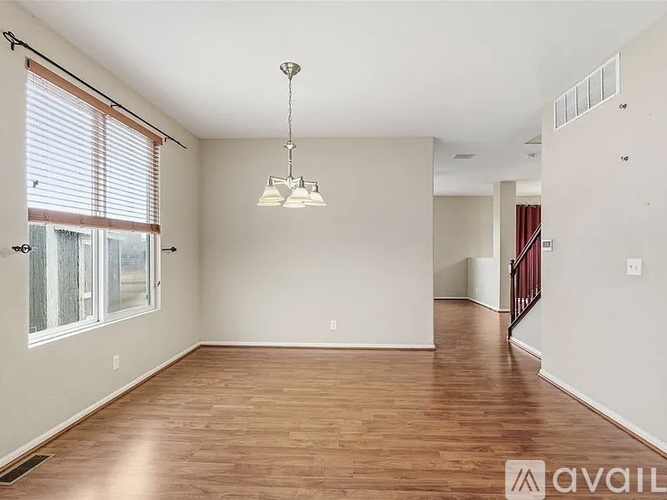A room with a carpeted floor and a window on the wall.