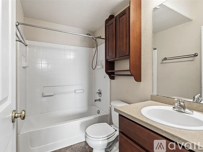 A room with a carpeted floor and a door leading to another room.