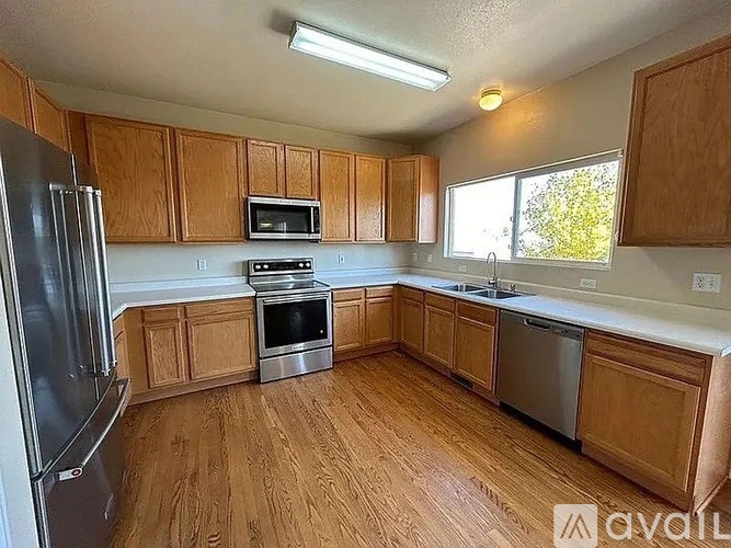 A kitchen with wooden cabinets and stainless steel appliances.
