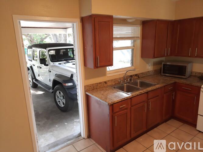 A kitchen with brown cabinets and a white stove.