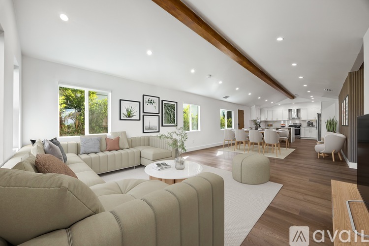 A modern living room with a large sectional sofa and a coffee table.