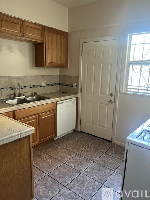 A kitchen with a white door and a washing machine.