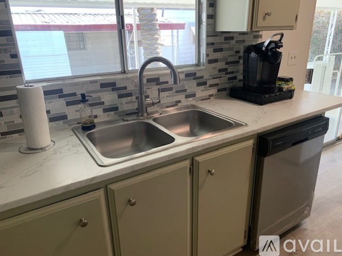A kitchen with a sink and a dishwasher.
