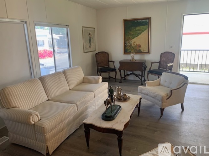 A living room with a couch, chair, and coffee table.