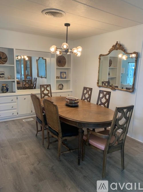 A dining room with a round table and chairs.