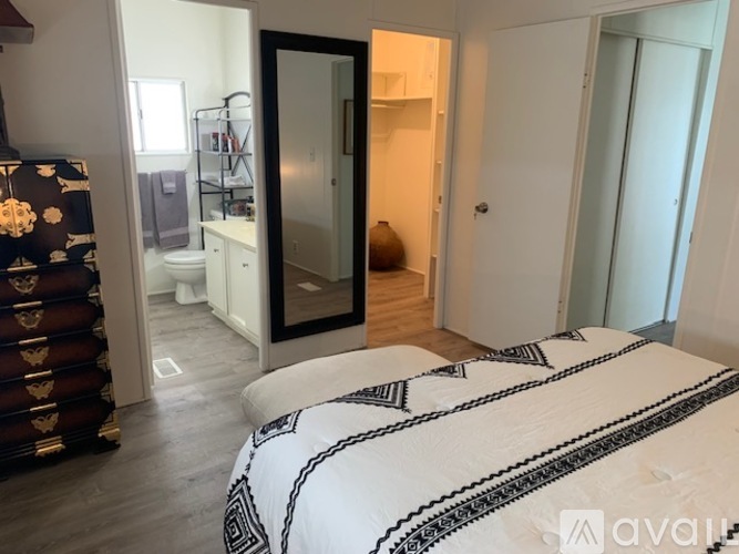 A bedroom with a large bed and a wardrobe.