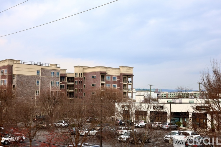 A parking lot with cars and a building in the background.