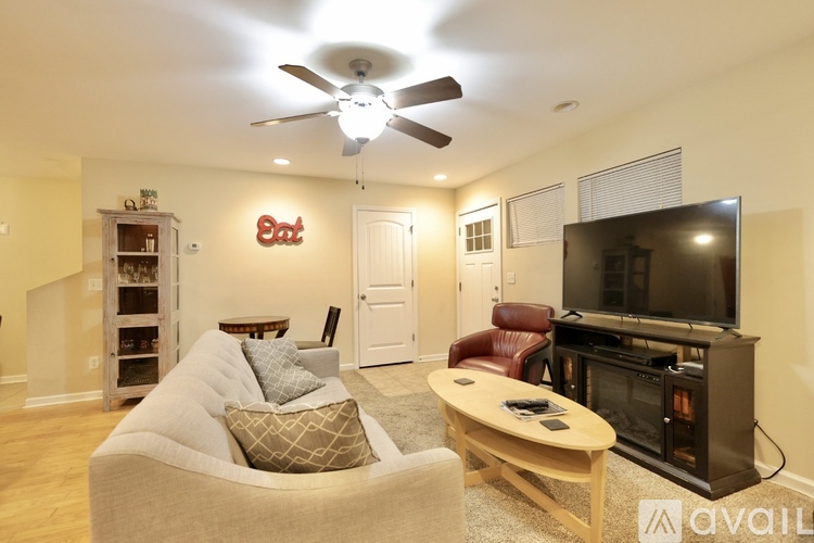 A living room with a television, a couch, and a coffee table.