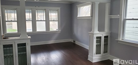 A room with a fireplace and a window.
