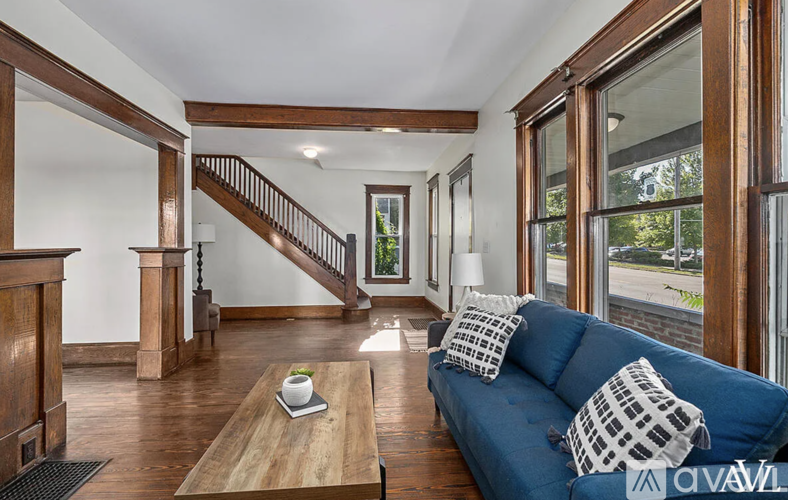 A living room with a blue couch and a wooden coffee table.
