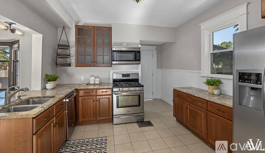 A kitchen with wooden cabinets and stainless steel appliances.
