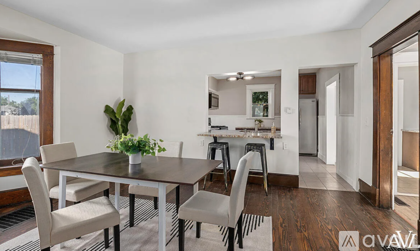 A dining room with a table and chairs is shown.