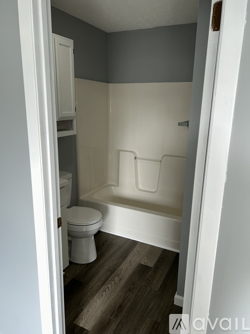 A small bathroom with a toilet and a bathtub.