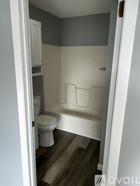 A small bathroom with a toilet and a bathtub.