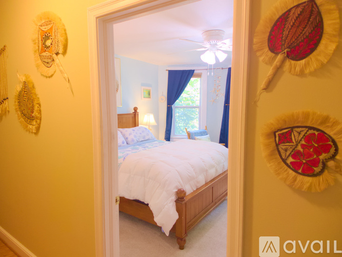 A bedroom with a bed and a window.