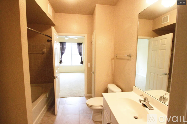 A bathroom with a toilet, sink, and bathtub.