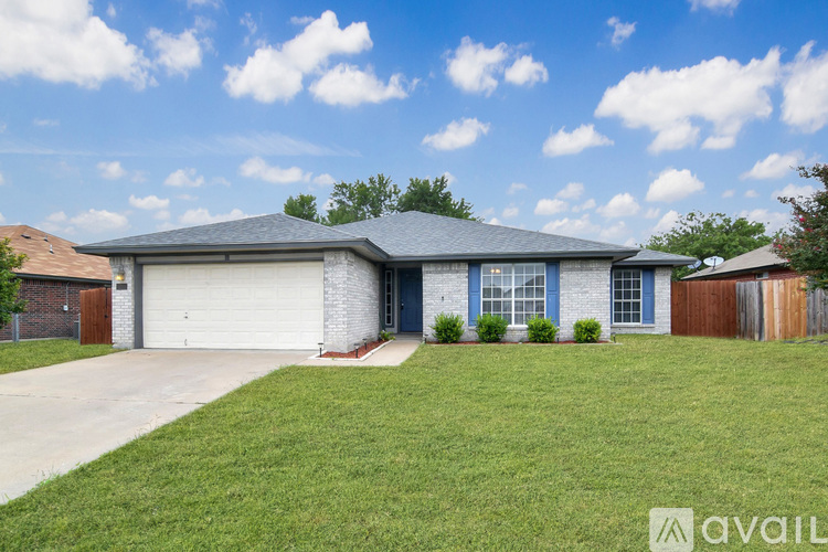 A house with a garage and a driveway in front.