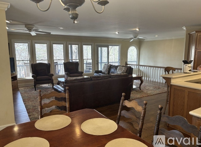 A dining room with a wooden table and chairs.