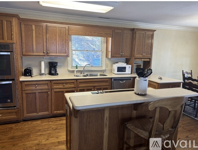 A kitchen with wooden cabinets and a white countertop.
