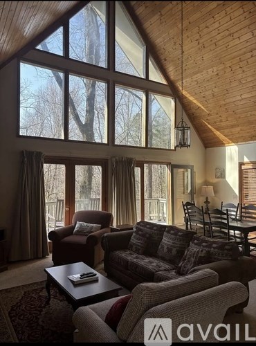 A living room with a couch, chairs, and a coffee table.