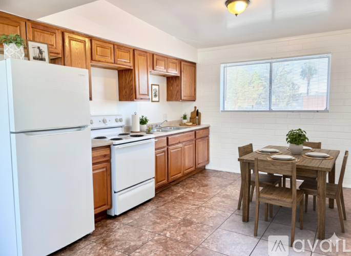 A kitchen with brown cabinets and a white refrigerator.