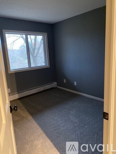 A room with a window and a door.