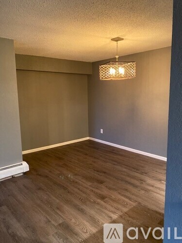 A room with wooden flooring and a light fixture.