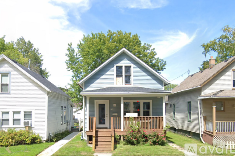 A house with a blue front and a porch.