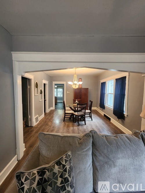 A living room with a grey couch and a wooden table.