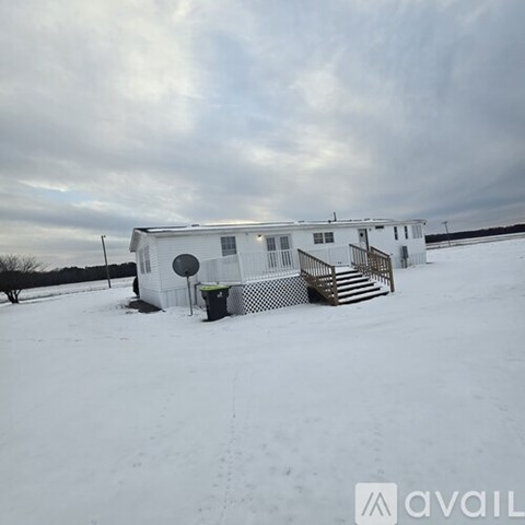 A room with a wood floor and a stone fireplace is available for rent in Spring, NC.