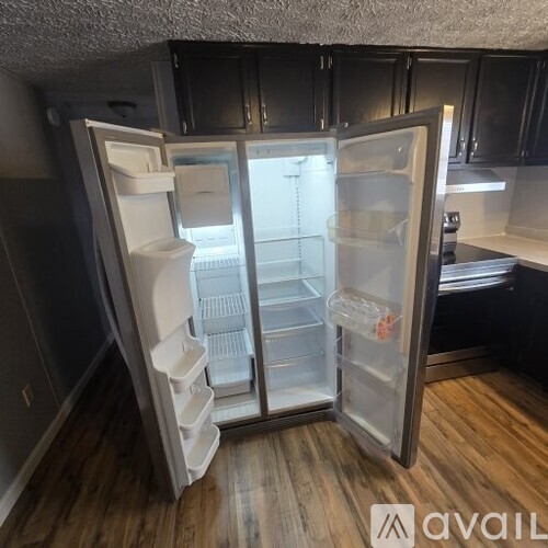 A refrigerator with its door open in a kitchen.