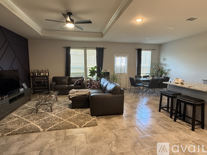 A living room with a fireplace and a rug on the floor.
