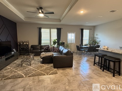A living room with a fireplace and a rug on the floor.