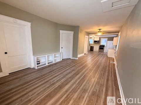 A room with wooden flooring and white doors.