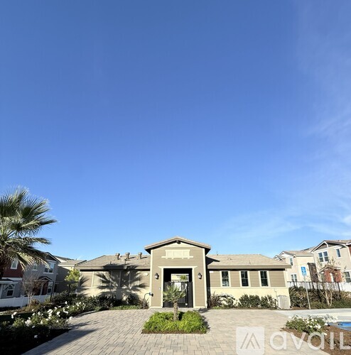 A house with a driveway and a pool in front.