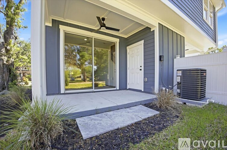 A brown wooden door with a glass window in the middle.