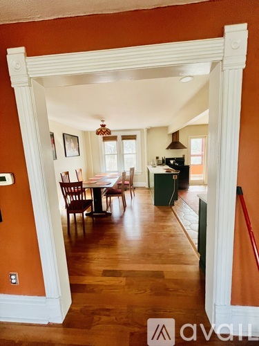 A view of a dining room through an archway.