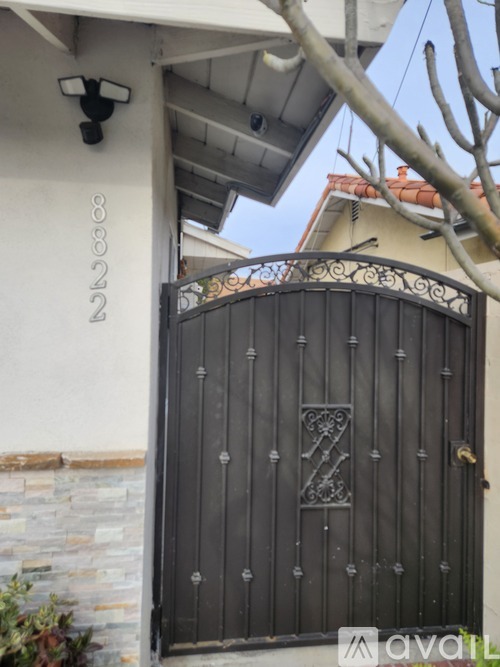 A black gate with a decorative design in the middle.