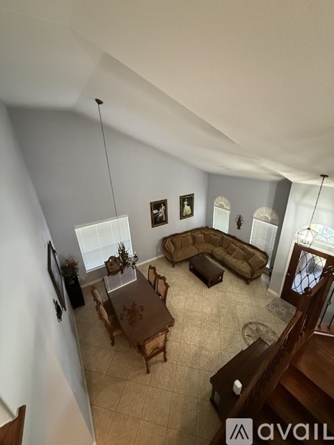 A living room with a brown couch and a brown table.