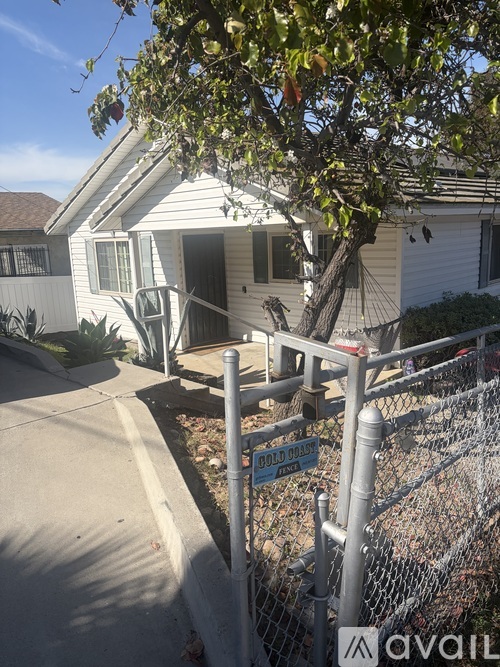 A house with a fence and a sign that says "FLOOD ZONE".