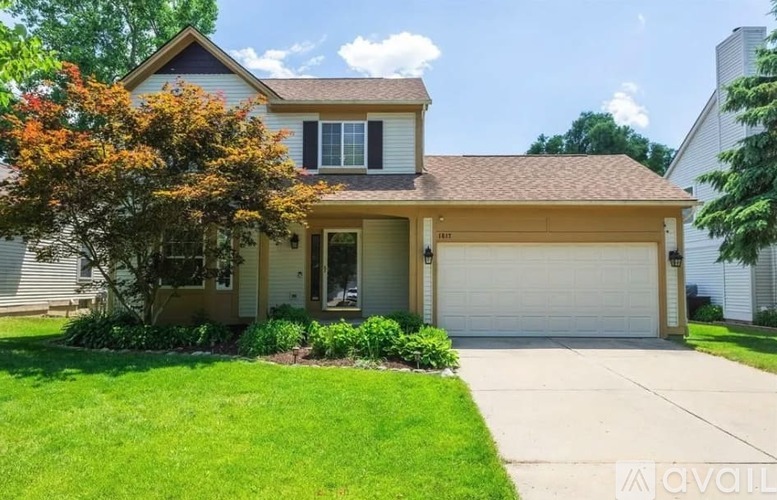 A house with a brown roof and a white garage door.