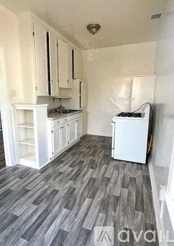 A kitchen with white cabinets and a washing machine.
