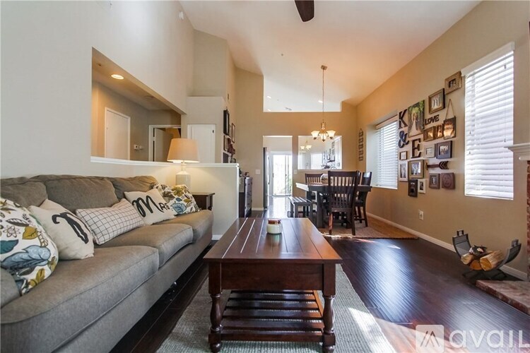 A living room with a grey couch and a wooden coffee table.