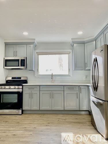 A kitchen with a stove, oven, microwave, and refrigerator.