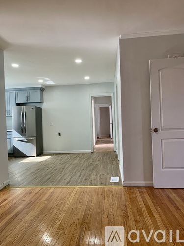 A room with wooden flooring and a white door.