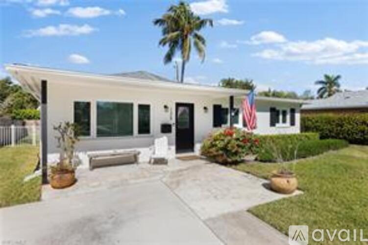 A house with a flag on the front porch is for sale.